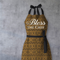 Keepsake lane Bless the Chef kitchen apron with brown and black geometric pattern and elegant white script text.