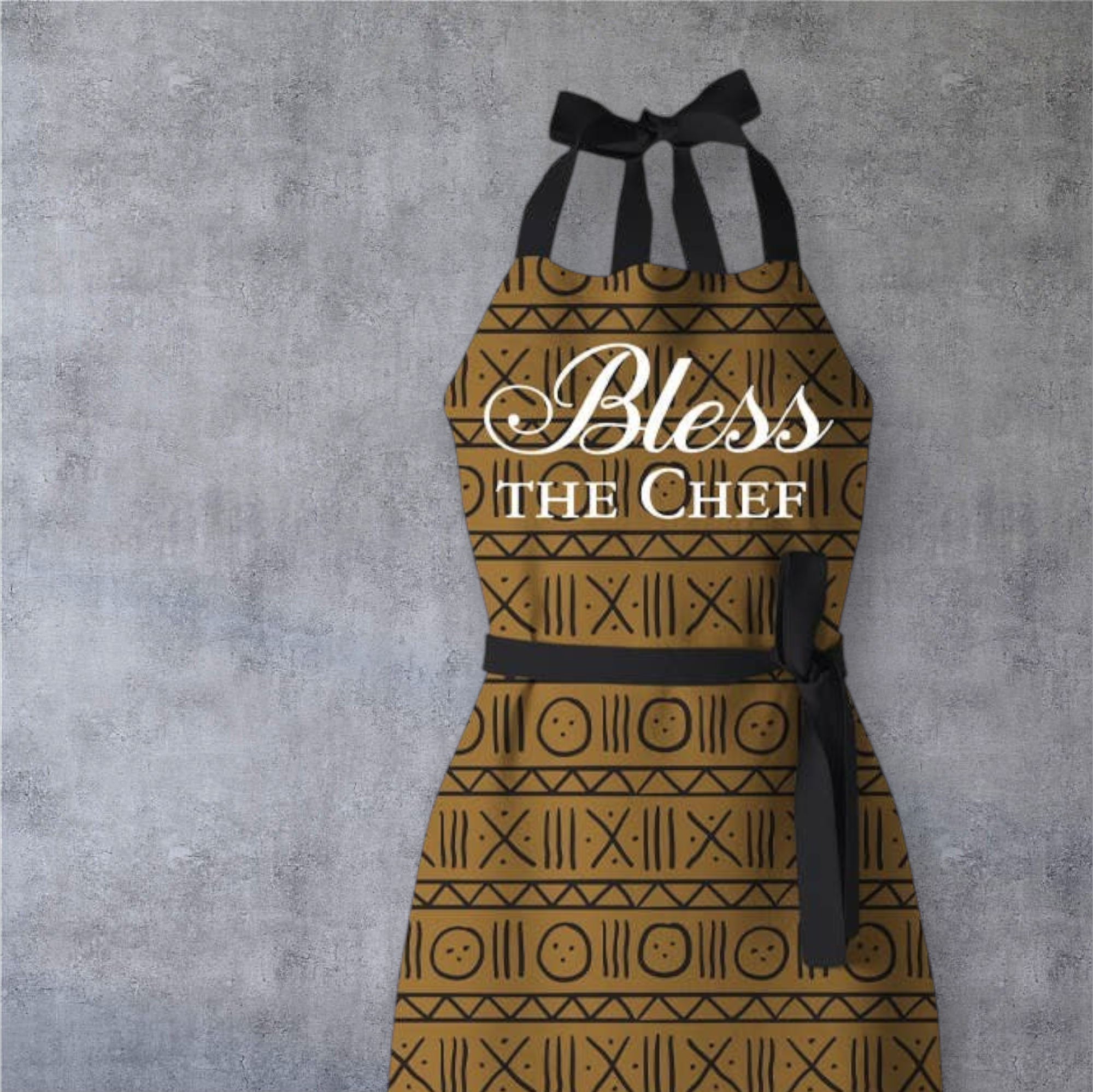 Keepsake lane Bless the Chef kitchen apron with brown and black geometric pattern and elegant white script text.