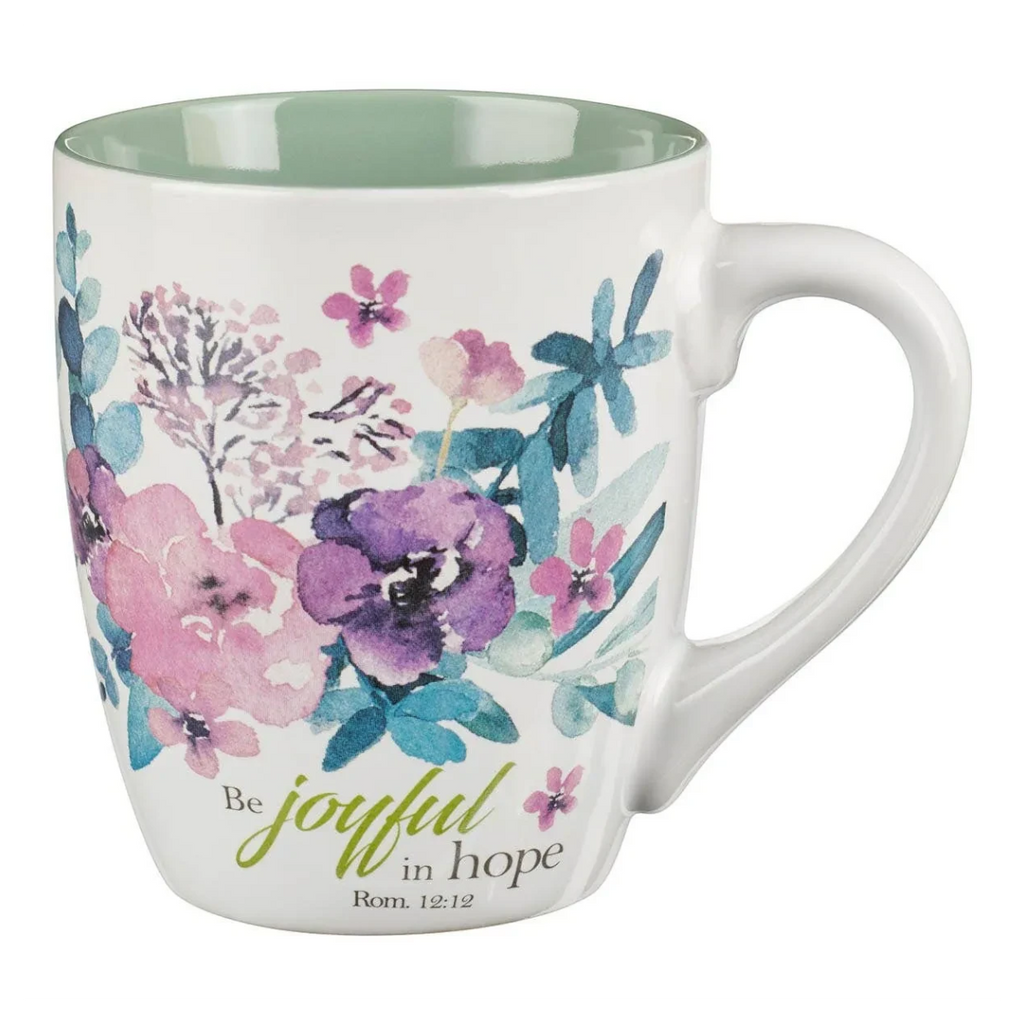 Keepsake lane ceramic mug with watercolor floral print and Be Joyful in Hope text, featuring a sage green interior.
