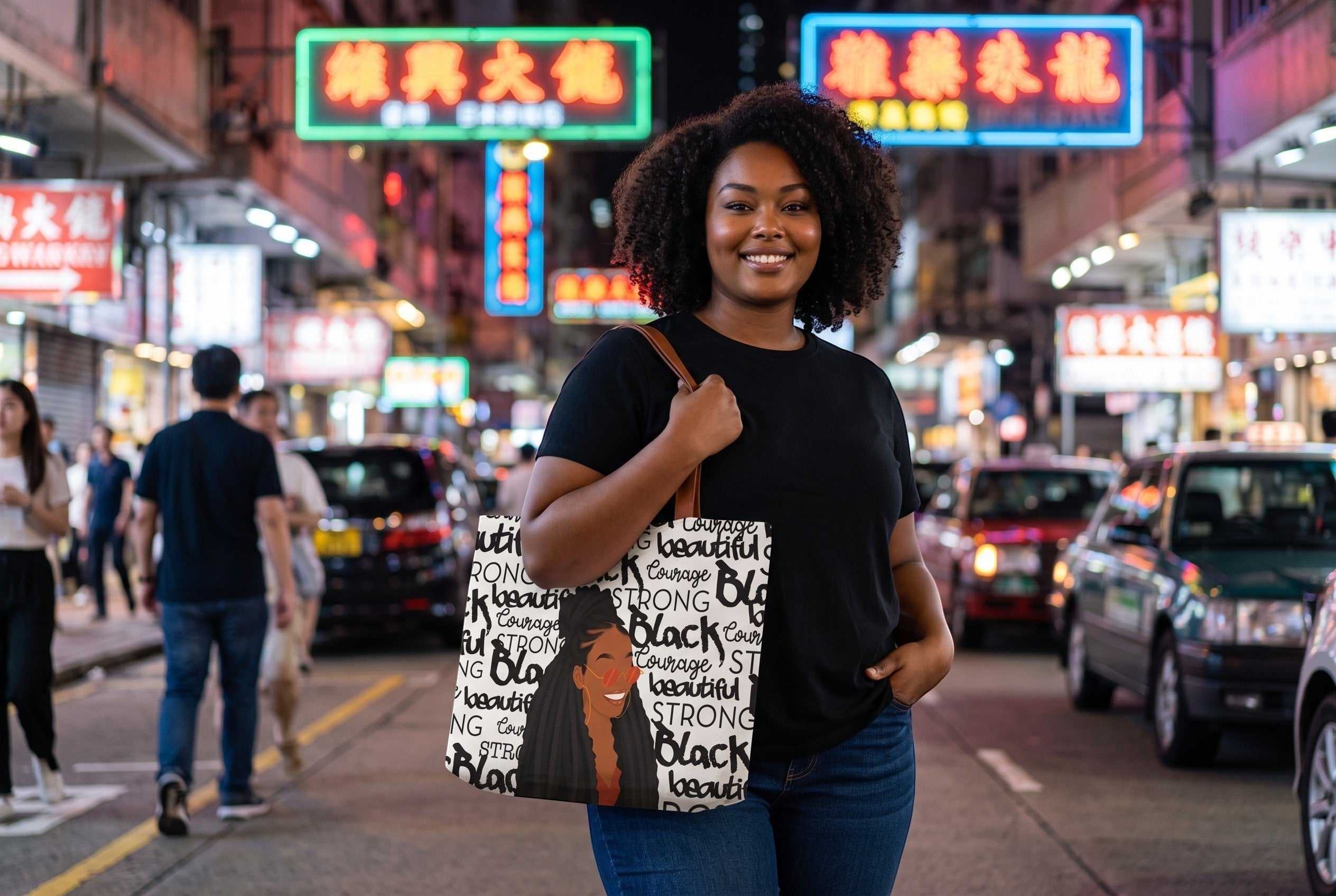 A woman carrying a Keepsake lane white tote bag with black inspirational typography and an illustration in a city.