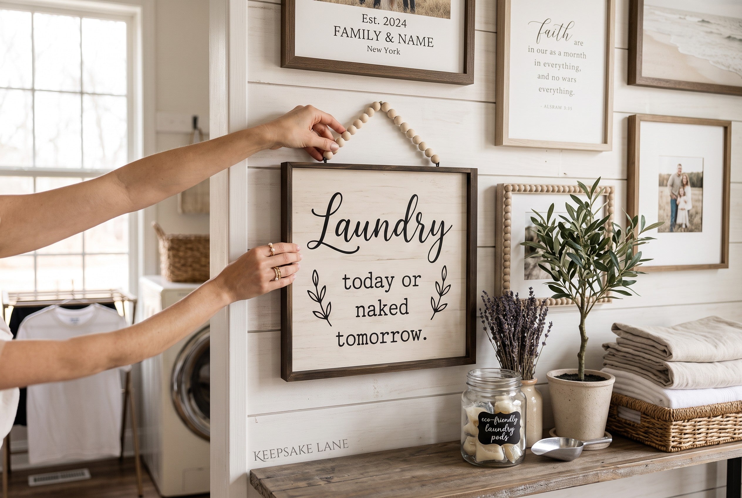 Keepsake lane rustic wood laundry wall sign with black typography and decorative beaded hanging cord in a laundry room