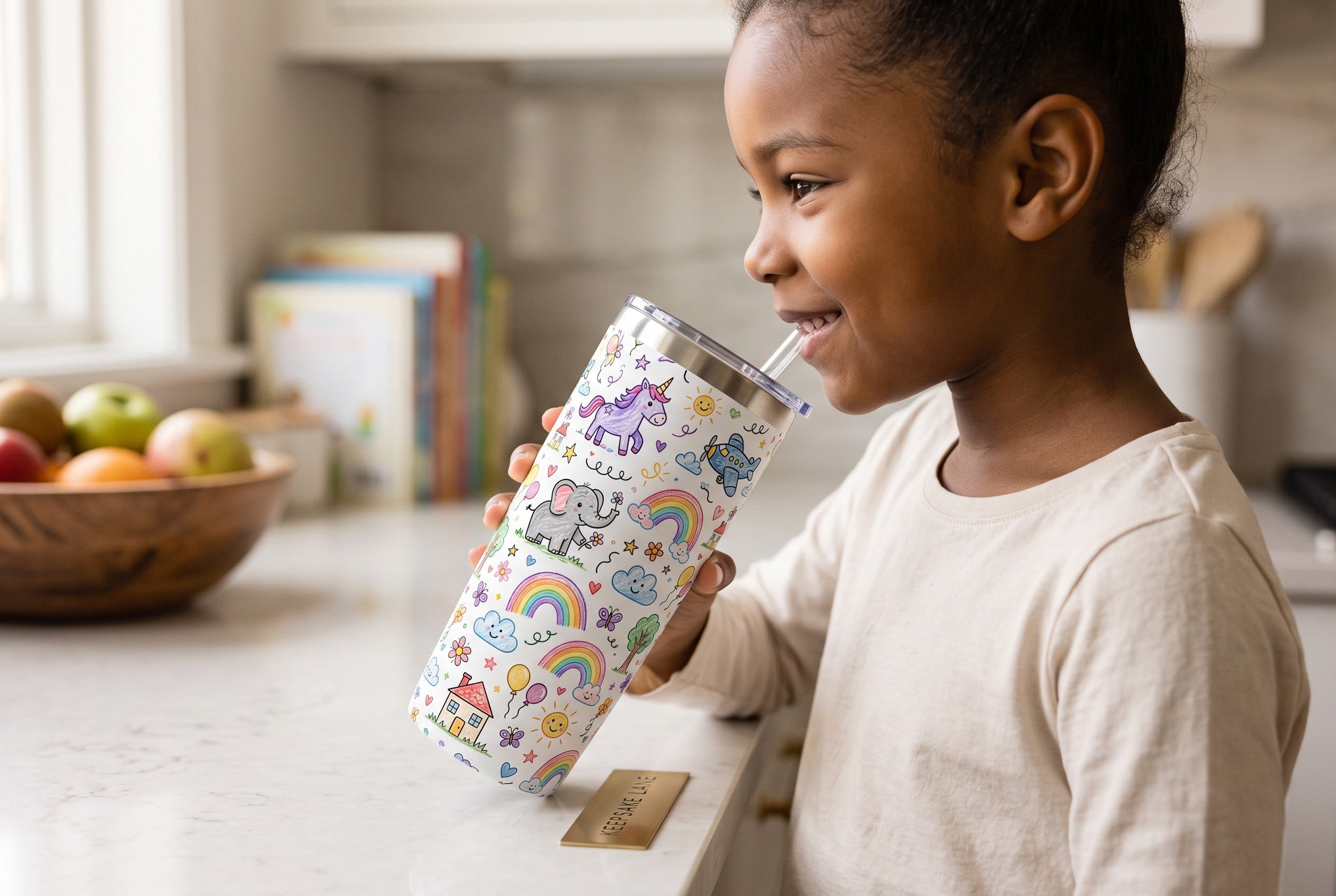 A young girl smiling while holding a Keepsake lane stainless steel tumbler with a colorful unicorn doodle pattern.
